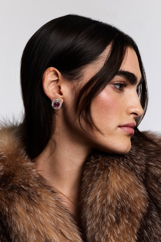 SIDE PROFILE OF A MODEL WITH BROWN HAIR WEARING A BROWN FUR JACKET AND THE FRANCES RED OVAL BUTTON EARRINGS