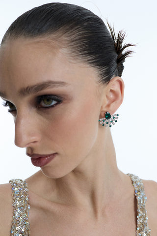 SIDE PROFILE OF A MODEL LOOKING SLIGHTLY UPWARD, AS SHE WEARS HER HAIR IN A SPIKY SLICK-BACK BUN, A GOLD SPARKLY DRESS, AND THE FRANCES GREEN FLARE STUD EARRINGS