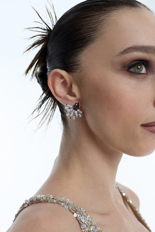SIDE PROFILE OF A MODEL WITH A SPIKY SLICK-BACK BUN, AS SHE WEARS A GOLD SPARKLY DRESS AND THE FRANCES BLACK FLARE STUD EARRINGS