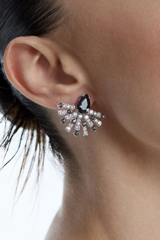 CLOSE UP OF A MODEL’S EAR AS SHE WEARS HER HAIR IN A SLICK-BACK BUN AND THE FRANCES BLACK FLARE STUD EARRINGS IN HER EAR