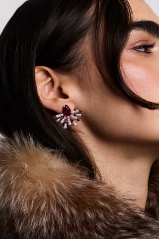 SIDE PROFILE OF A MODEL WITH BROWN HAIR WEARING A BROWN FUR JACKET AND THE FRANCES PINK FLARE STUD EARRINGS