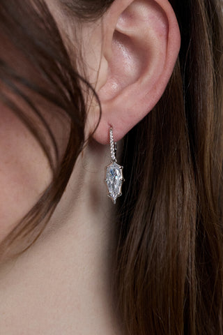 CLOSE UP OF A MODEL’S EAR WITH HER HAIR TUCKED BEHIND IT AND WEARING THE SUPERNOVA DROP LEVERBACK EARRINGS