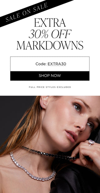 Sale on sale. Extra 30% off markdowns with code EXTRA30. Full price styles excluded. Image of model wearing cubic zirconia necklaces with clear and black stones.
