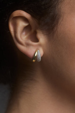CLOSE UP OF A MODEL’S EAR WEARING THE GEMINI DOUBLE ILLUSION HOOP EARRINGS