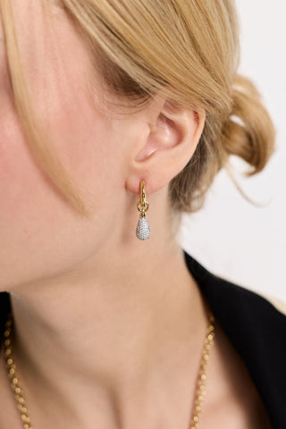 CLOSE UP OF A MODEL’S EAR WITH HER HAIR PULLED BACK, WEARING THE GEMINI PAVE DROP HUGGIE EARRINGS