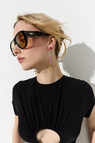 MODEL TURNED TO THE SIDE WITH HER HAIR UP, WEARING A BLACK TOP, SUNGLASSES, AND THE MOJITO MULTI LINEAR EARRINGS