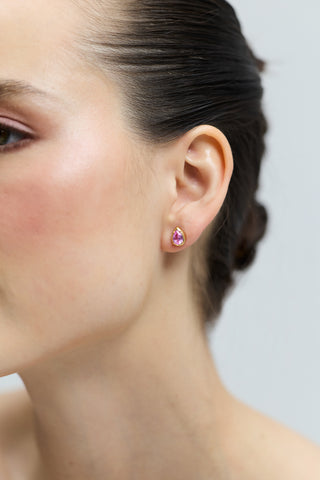CLOSE UP OF A MODEL’S EAR WEARING THE PEAR STUD FROM THE DELANCEY PINK STUD SET OF EARRINGS