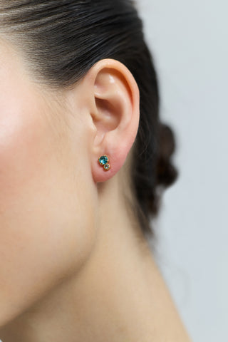 CLOSE UP OF A MODEL’S EAR WEARING THE DOUBLE STONE STUD FROM THE DELANCEY AQUA STUD SET OF EARRINGS