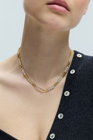 CLOSE UP OF A MODEL’S CHEST AS SHE WEARS A GRAY SWEATER AND THE DELANCEY ALL AROUND COLLAR NECKLACE