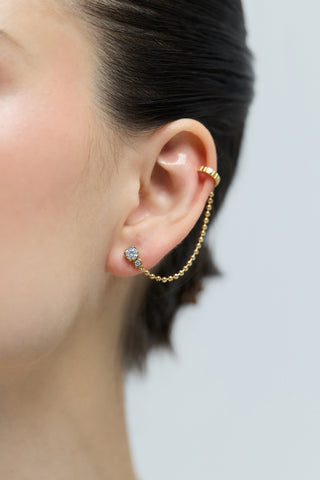 CLOSE UP OF A MODE’S EAR WEARING THE DELANCEY SINGLE SWAG CUFF EARRINGS