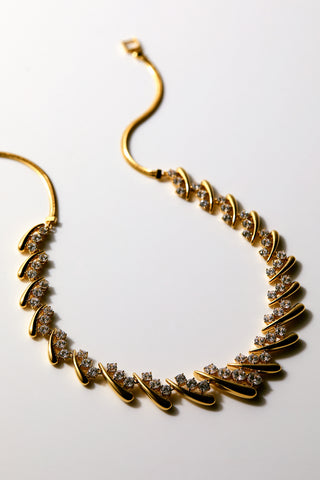 PHENOM LARGE COLLAR NECKLACE ON A NEUTRAL BACKGROUND