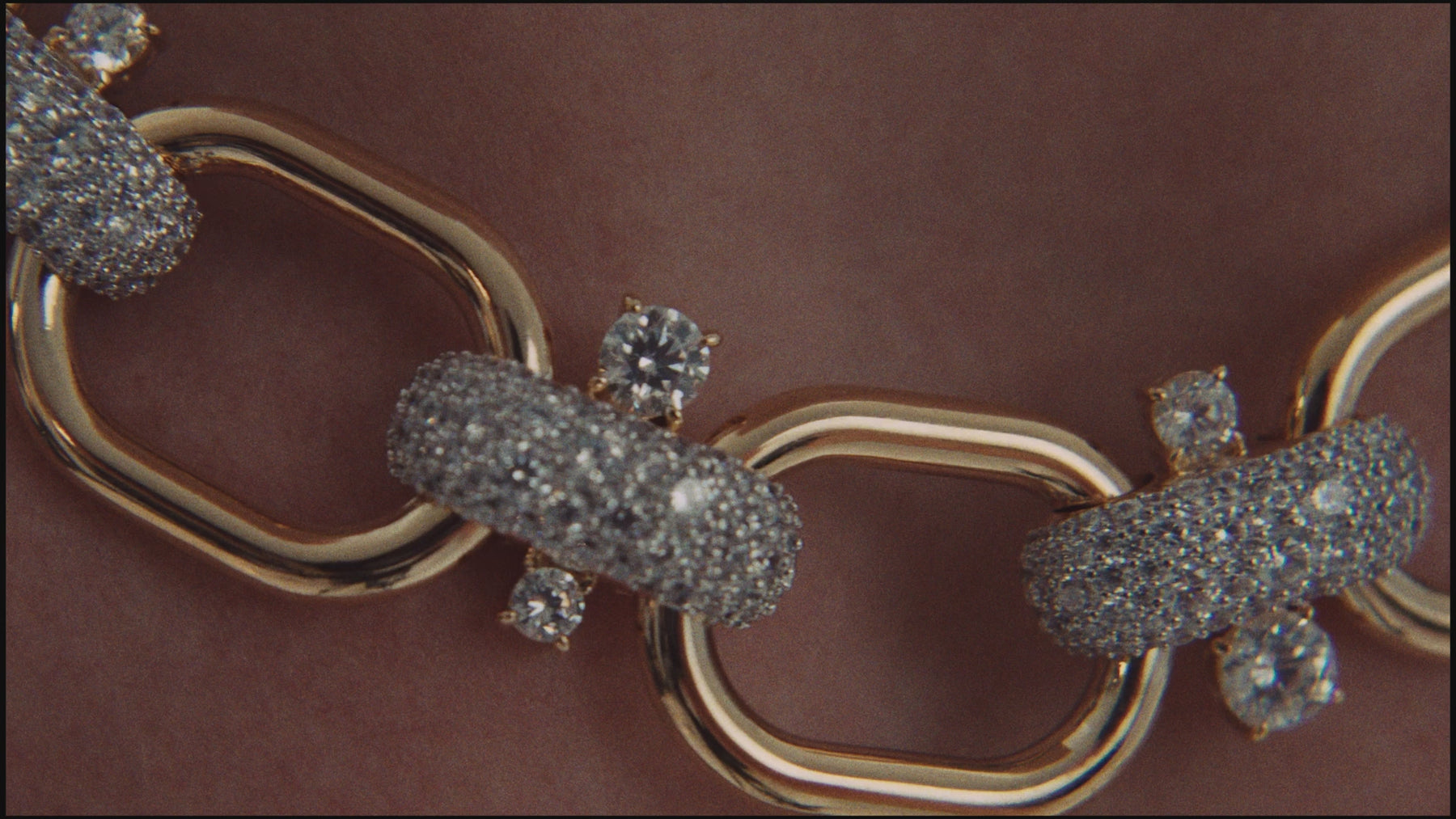 Video of a model wearing Nadri's Turn Up The Volume collection of crushed cubic zirconia statement jewelry in a two-tone finish. She is wearing a festive floor-length sequin gown. 