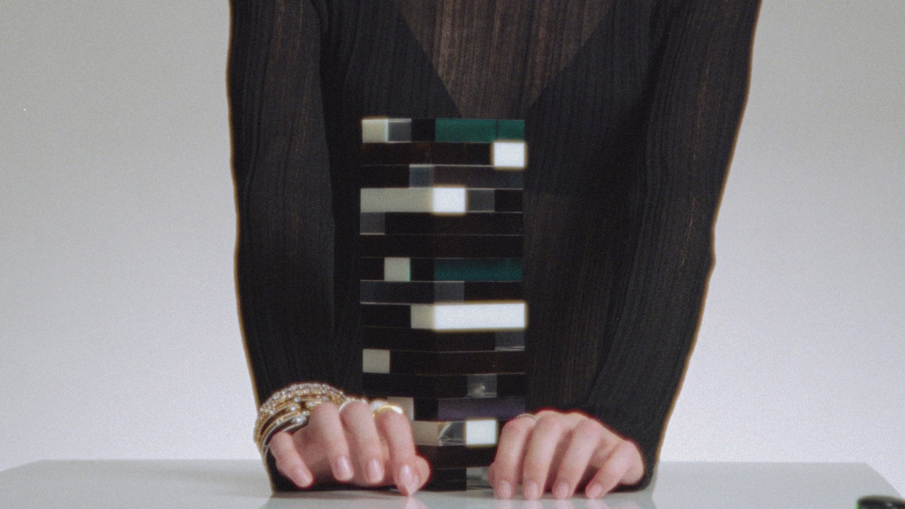 Video of a model  playing the game Jenga while wearing a stack of Nadri bracelets and rings.