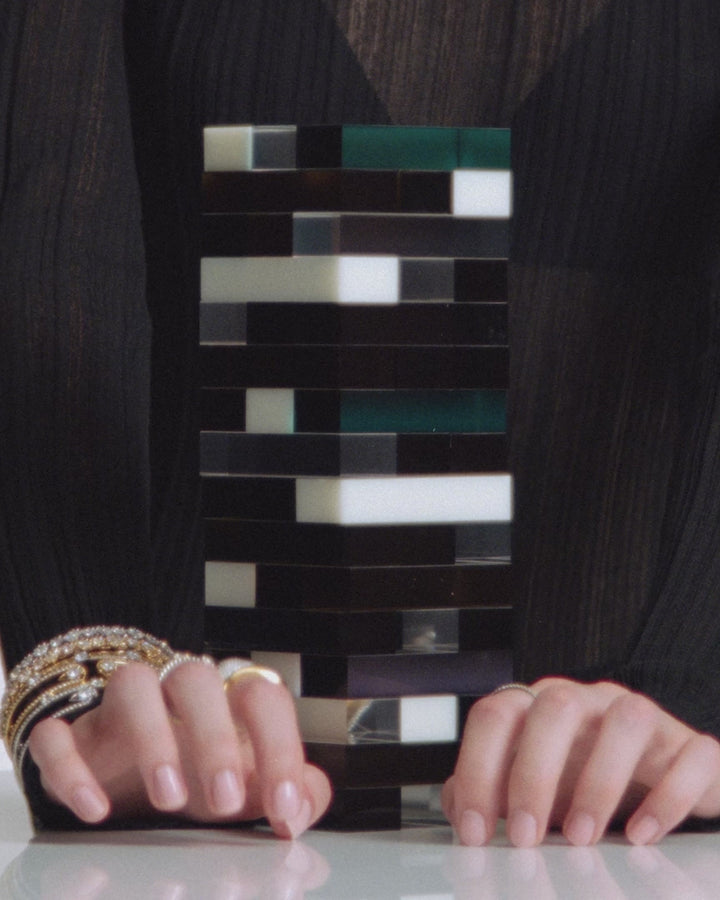 Video of a model  playing the game Jenga while wearing a stack of Nadri bracelets and rings.