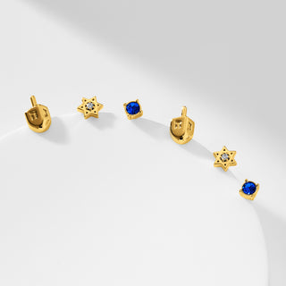 Gold dreidel, gold Star of David, and blue stone stud earrings