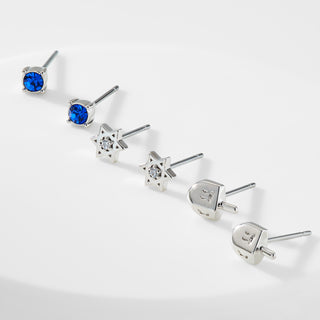 Silver dreidel, sold Star of David, and blue stone stud earrings