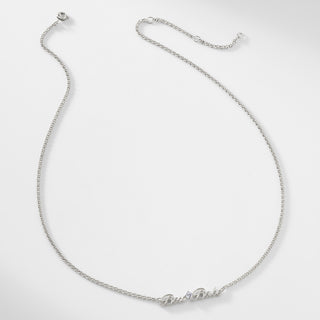 A silver chain necklace that says "Boss Babe" with a single cubic zirconia stone